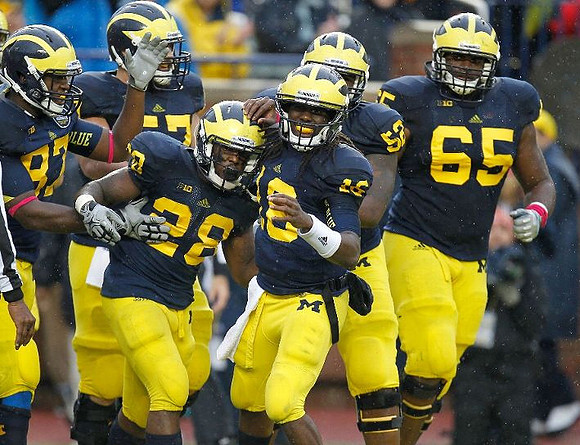 Brandon Moore (87), Taylor Lewan (77), Fitzgerald Toussaint (28), Denard Robinson (16), Ricky Barnum (52), and Patrick Omameh (65)