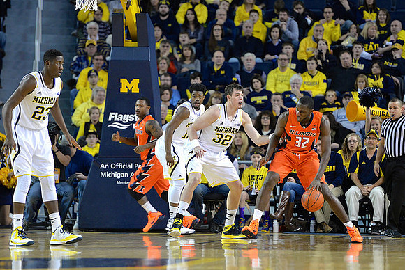 Caris LeVert (23), Derrick Walton Jr. (10), and Ricky Doyle (32)