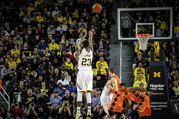Caris LeVert (23) and Ricky Doyle (32)