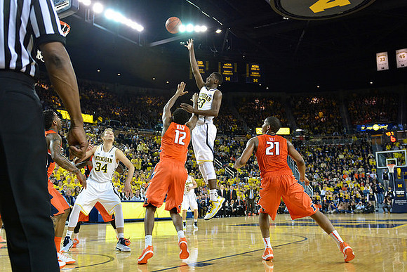 Mark Donnal (34), Caris LeVert (23), and Spike Albrecht (2)