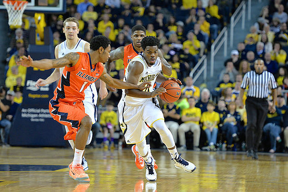 Mark Donnal (34) and Derrick Walton Jr. (10)