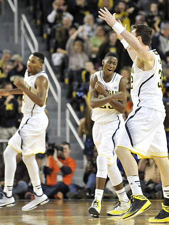 Zak Irvin (21), Caris LeVert (23), and Ricky Doyle (32)
