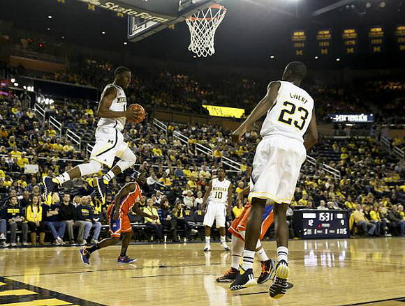 Glenn Robinson III (1), Derrick Walton Jr. (10), and Caris LeVert (23)