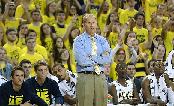 Andrew Dakich (5), Mark Donnal (34), Jordan Morgan (52), John Beilein, Caris LeVert (23), and Glenn Robinson III (1)