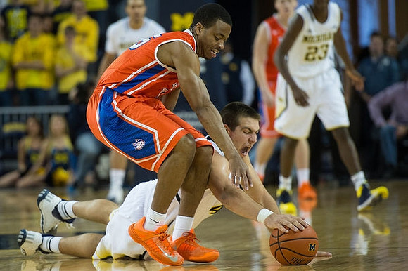Mitch McGary (4) and Caris LeVert (23)