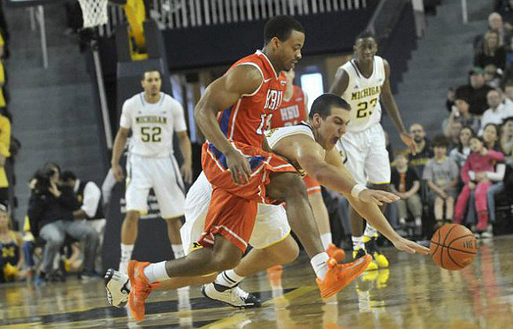 Jordan Morgan (52), Mitch McGary (4), and Caris LeVert (23)