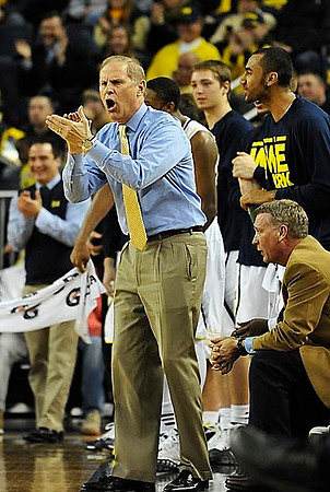 John Beilein, Jeff Meyer, Jon Horford (15), and Mark Donnal (34)