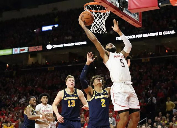 Zavier Simpson (3), Ignas Brazdeikis (13), and Jordan Poole (2)