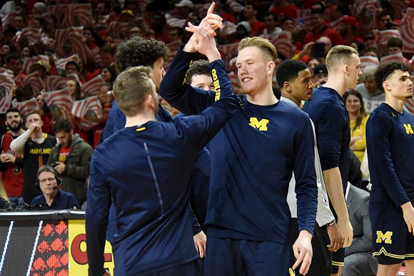 Ignas Brazdeikis (13) and Michigan Team