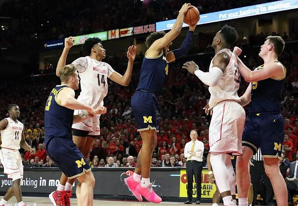 Ignas Brazdeikis (13), Isaiah Livers (4), Jon Teske (15), and John Beilein