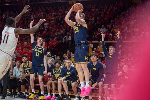 Ignas Brazdeikis (13) and Michigan Team