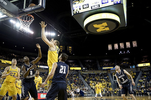Duncan Robinson (22), Muhammad-Ali Abdur-Rahkman (12), and Austin Davis (51)