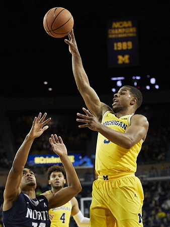 Zavier Simpson (3) and Isaiah Livers (4)