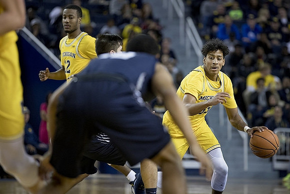 Muhammad-Ali Abdur-Rahkman (12) and Eli Brooks (55)