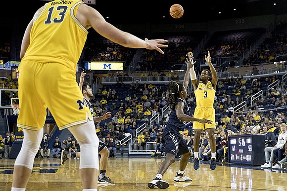 Moritz Wagner (13) and Zavier Simpson (3)