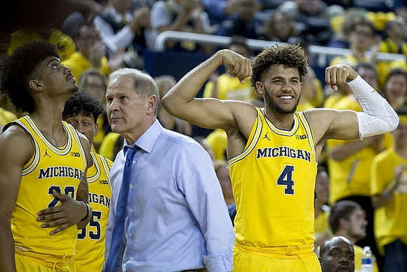 Ibi Watson (23), Eli Brooks (55), John Beilein, and Isaiah Livers (4)