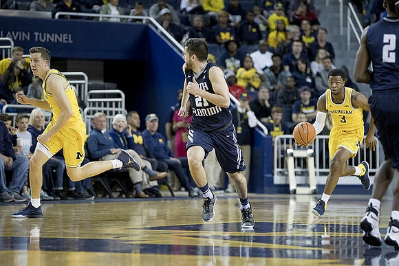 Duncan Robinson (22) and Zavier Simpson (3)