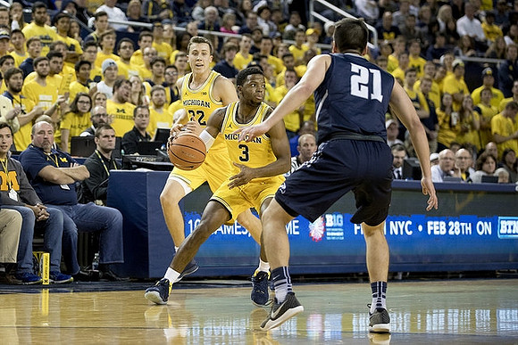 Duncan Robinson (22) and Zavier Simpson (3)