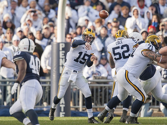 Jake Rudock (15), Mason Cole (52), and Ben Braden (71)