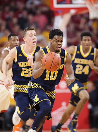 Duncan Robinson (22), Derrick Walton Jr. (10), and Aubrey Dawkins (24)