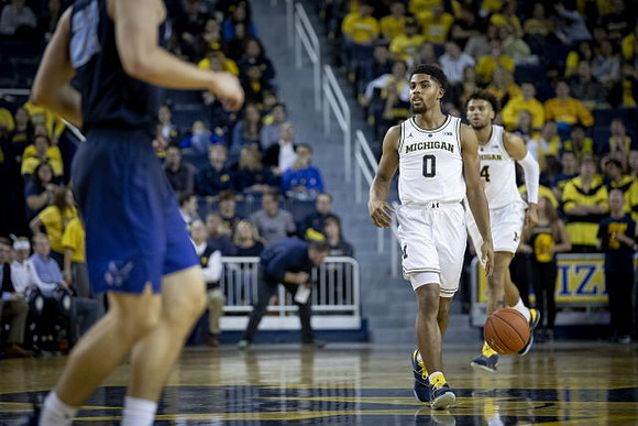 David DeJulius (0) and Isaiah Livers (4)
