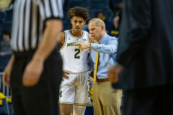 Jordan Poole (2) and John Beilein