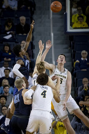 Isaiah Livers (4), Ignas Brazdeikis (13), and Jon Teske (15)