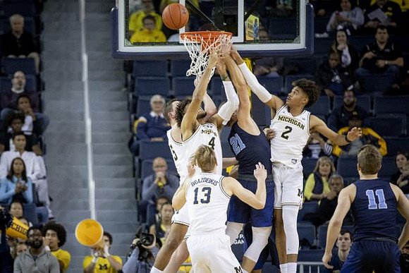 Jon Teske (15), Ignas Brazdeikis (13), Isaiah Livers (4), and Jordan Poole (2)