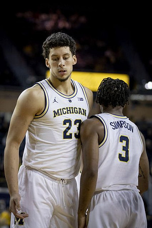 Brandon Johns Jr. (23) and Zavier Simpson (3)