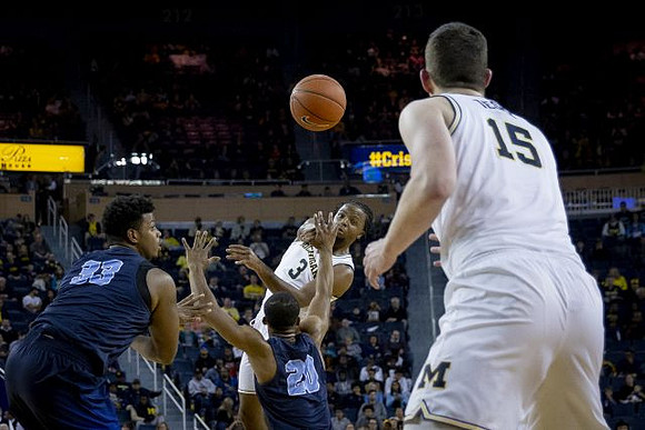 Zavier Simpson (3) and Jon Teske (15)