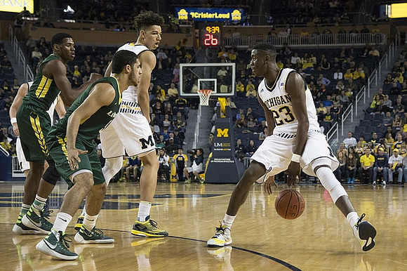 D.J. Wilson (5) and Caris LeVert (23)
