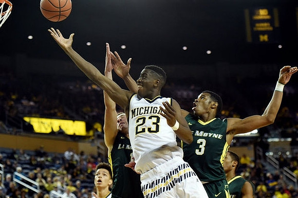 D.J. Wilson (5) and Caris LeVert (23)