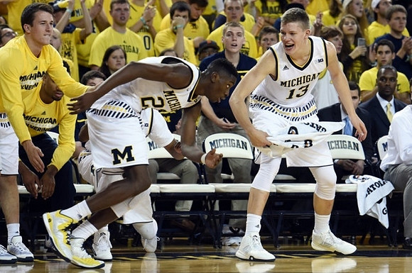 Andrew Dakich (11), Caris LeVert (23), and Moritz Wagner (13)