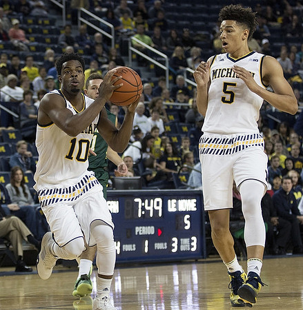 Derrick Walton Jr. (10) and D.J. Wilson (5)