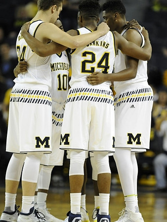 Mark Donnal (34), Derrick Walton Jr. (10), and Aubrey Dawkins (24)