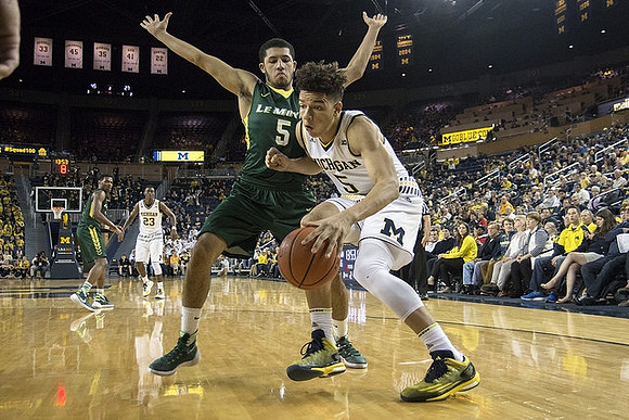 D.J. Wilson (5) and Caris LeVert (23)