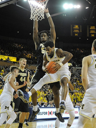 Moritz Wagner (13), Derrick Walton Jr. (10), and Duncan Robinson (22)