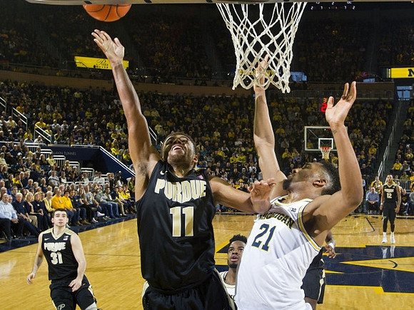 Zak Irvin (21) and Derrick Walton Jr. (10)