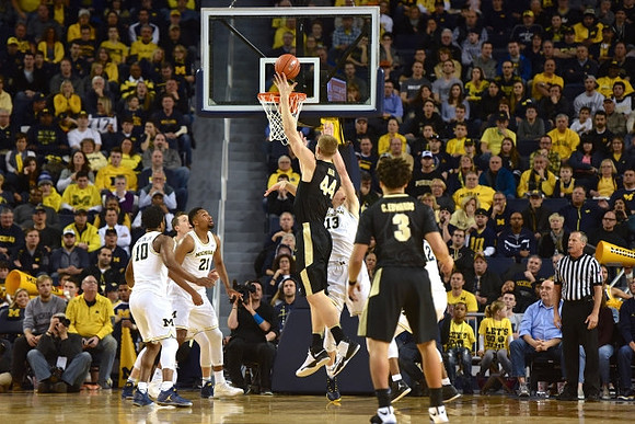 Derrick Walton Jr. (10), Zak Irvin (21), and Moritz Wagner (13)