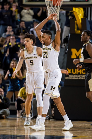 D.J. Wilson (5) and Zak Irvin (21)