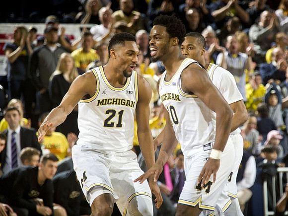 Zak Irvin (21), Derrick Walton Jr. (10), and Muhammad-Ali Abdur-Rahkman (12)
