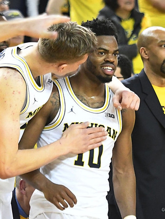 Moritz Wagner (13) and Derrick Walton Jr. (10)