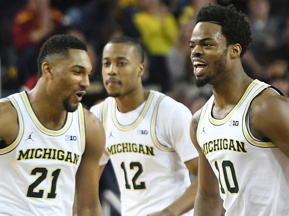 Zak Irvin (21), Muhammad-Ali Abdur-Rahkman (12), and Derrick Walton Jr. (10)