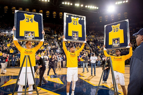 Mark Donnal (34), Zak Irvin (21), and Derrick Walton Jr. (10)