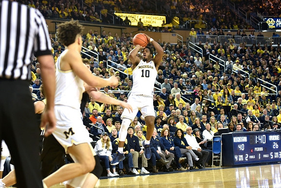 D.J. Wilson (5) and Derrick Walton Jr. (10)