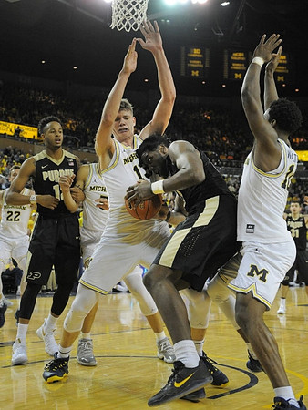 Duncan Robinson (22), D.J. Wilson (5), Moritz Wagner (13), and Derrick Walton Jr. (10)