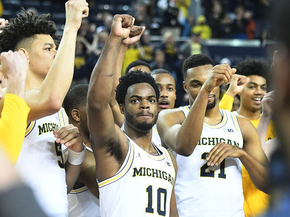 D.J. Wilson (5), Derrick Walton Jr. (10), Zak Irvin (21), and Michigan Team