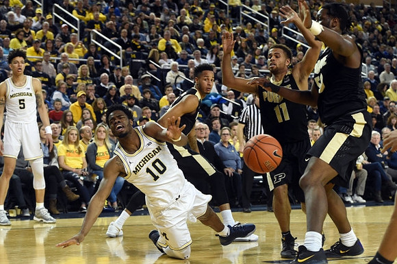 D.J. Wilson (5) and Derrick Walton Jr. (10)