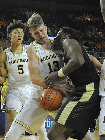 D.J. Wilson (5) and Moritz Wagner (13)