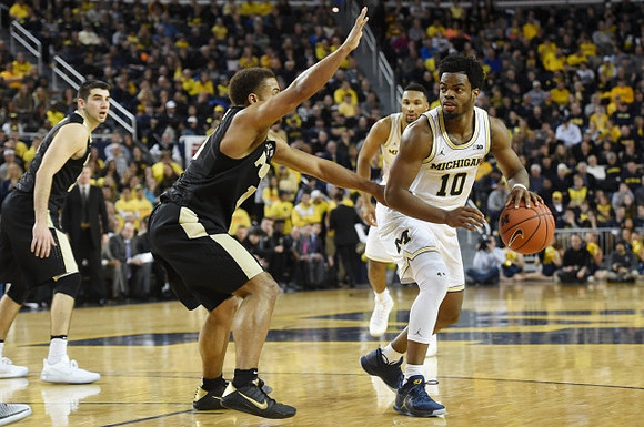 Zak Irvin (21) and Derrick Walton Jr. (10)